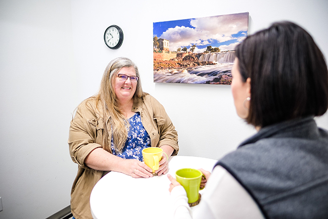 Photo of two women talking in Sioux Falls, SD office