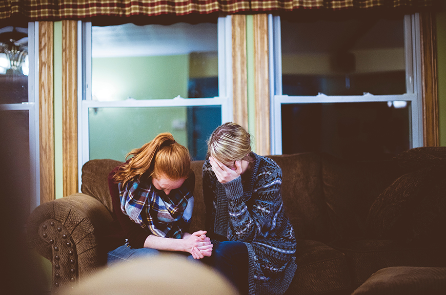 Photo of two women on a coach