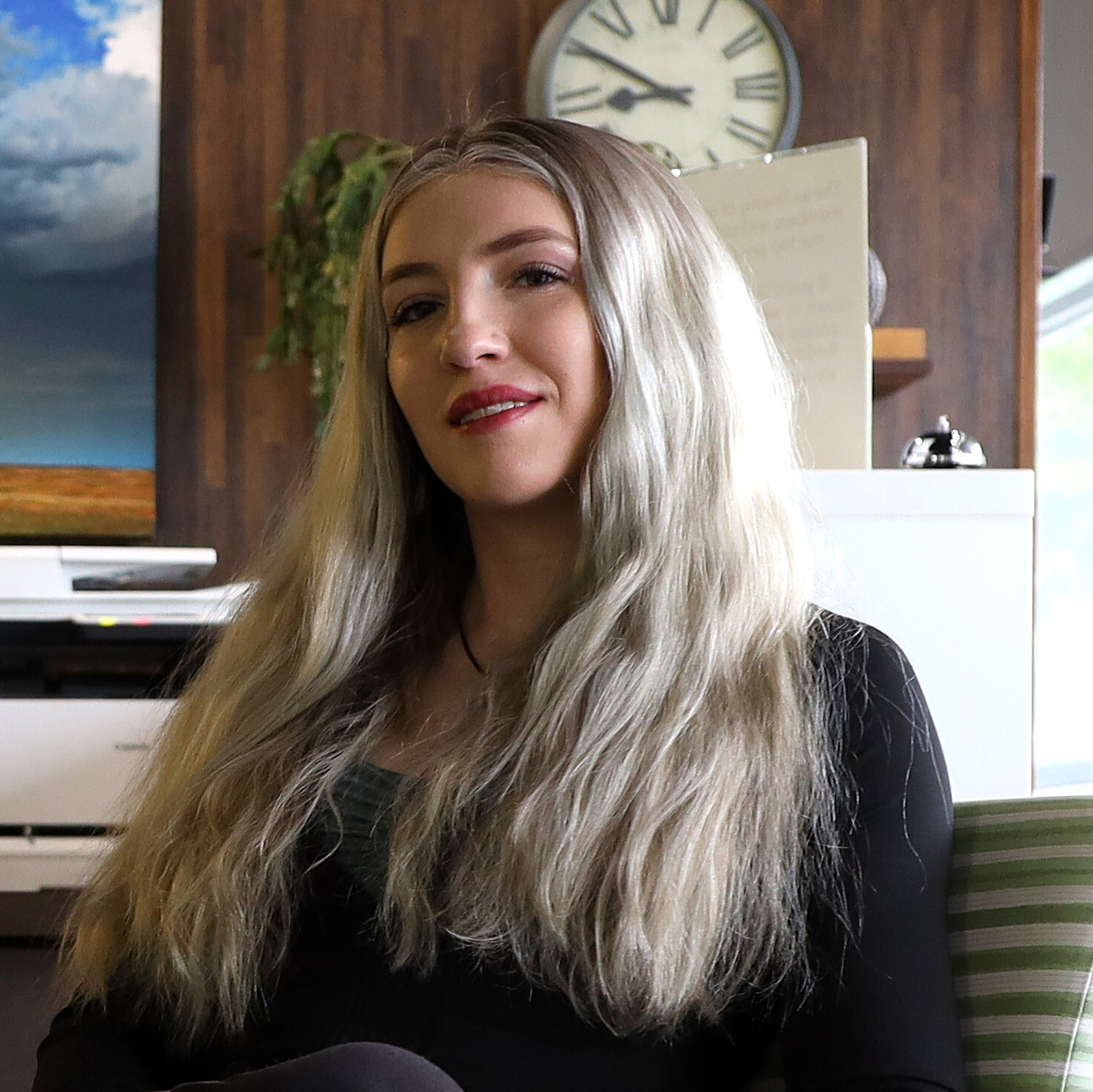 Photo of woman with long blonde hair sitting in office