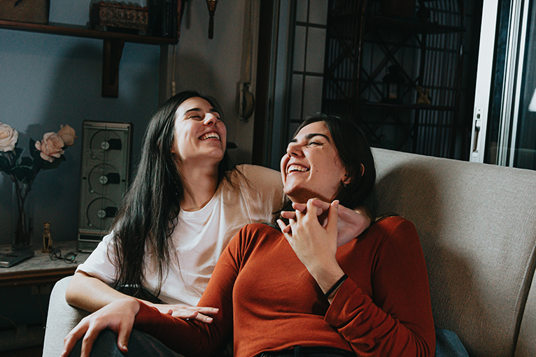 Photo of two women smiling and embracing
