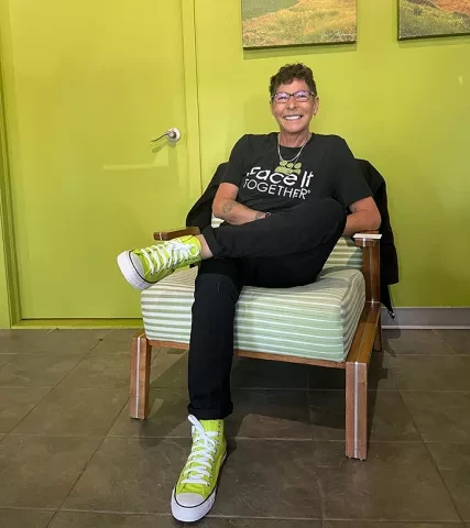 Photo of Terri, peer coach of 15 years, in her custom Converse