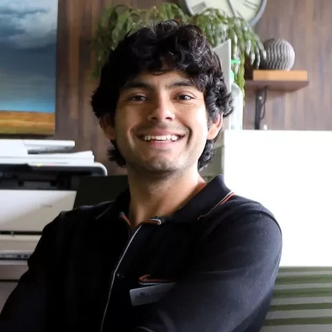 Photo of Carlos, young man sitting in office