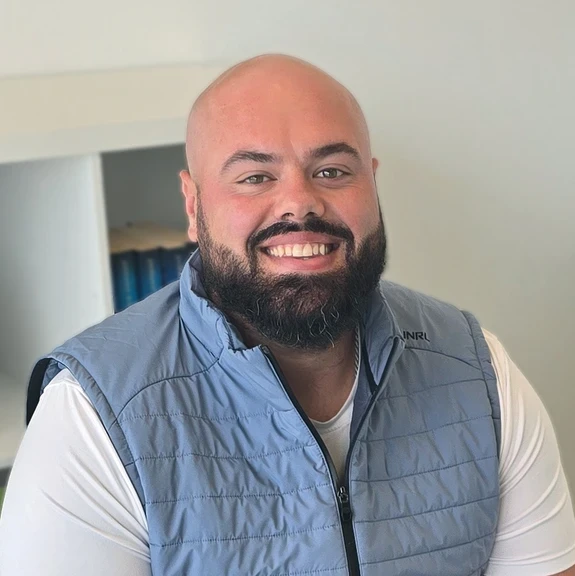 Photo of man sitting smiling at camera