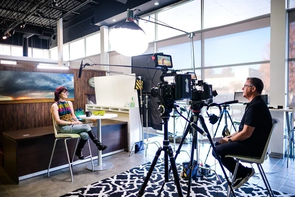 Photo of woman being interviewed on camera