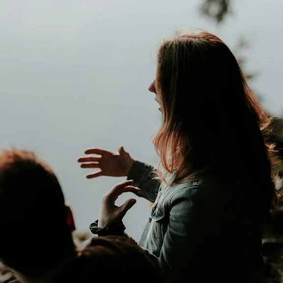 Photo of woman talking and gesturing with her hands