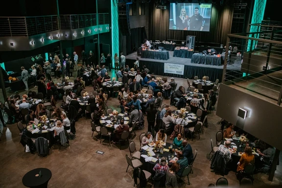 Photo of full tables near an event stage